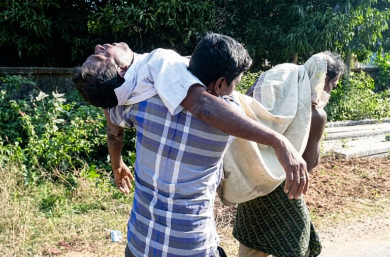 No road to the cremation ground; family members carried the body on their shoulders across farmland embankments.