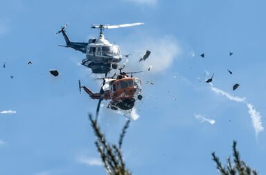 Two firefighting helicopters catch fire mid-air; two pilots killed.