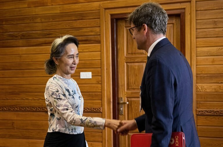 Red Cross officials meet Nobel Peace Prize laureate Aung San Suu Kyi, who remains under house arrest.